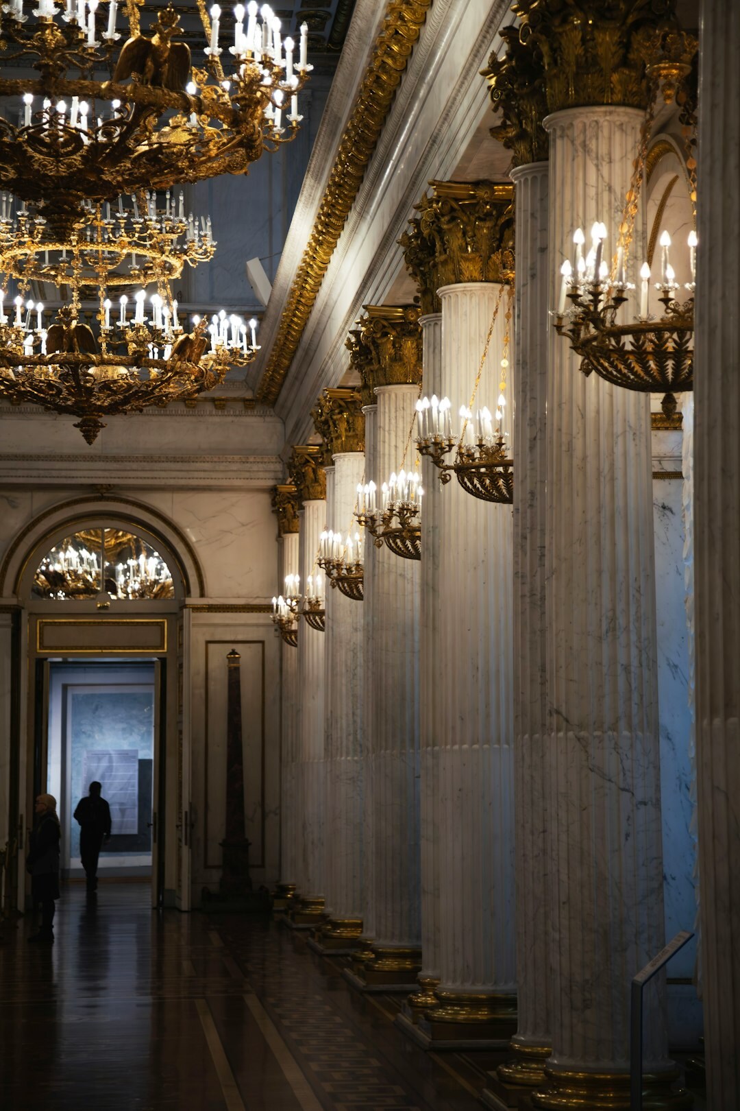 Elegant woman in evening gown walking through a marble hallway