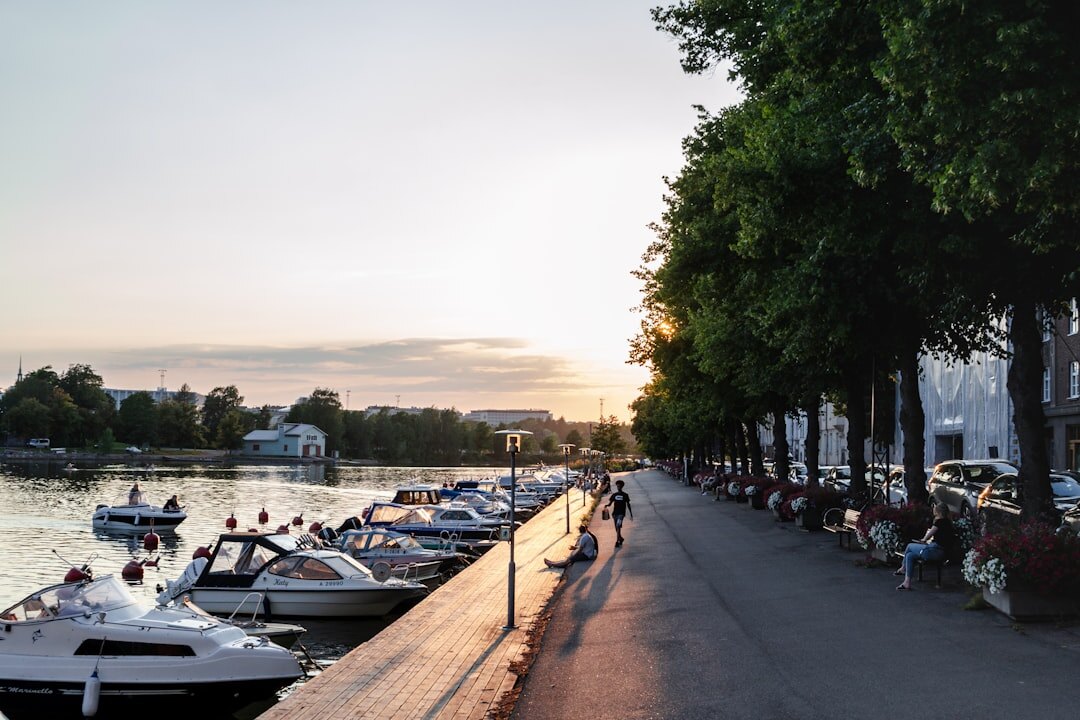 Silhouette of a woman on a river embankment at dusk