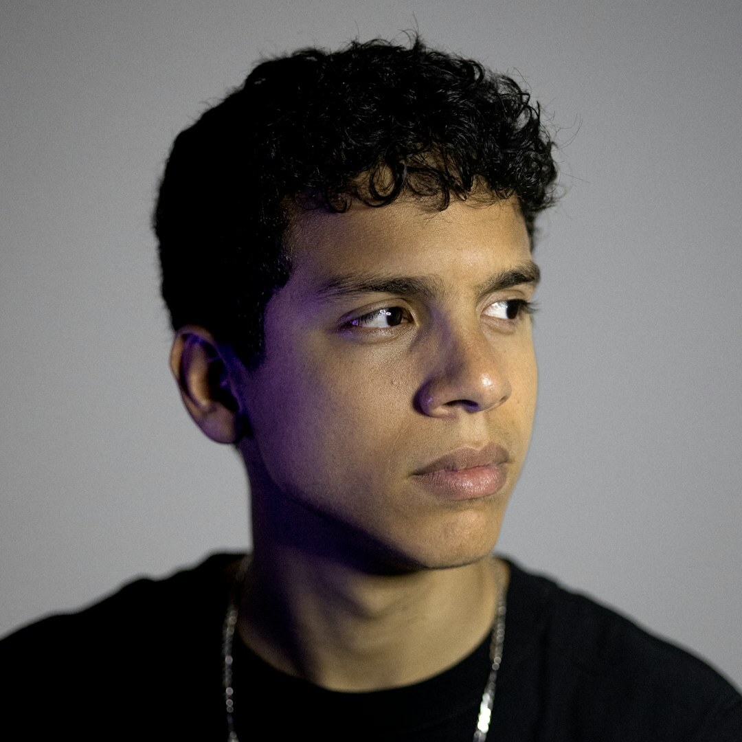 Studio portrait of a young Argentine man with curly hair